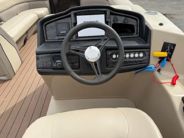 Slide: The Image of 2021 Bentley Pontoons 253 dashboard with steering wheel and control panel. - 11