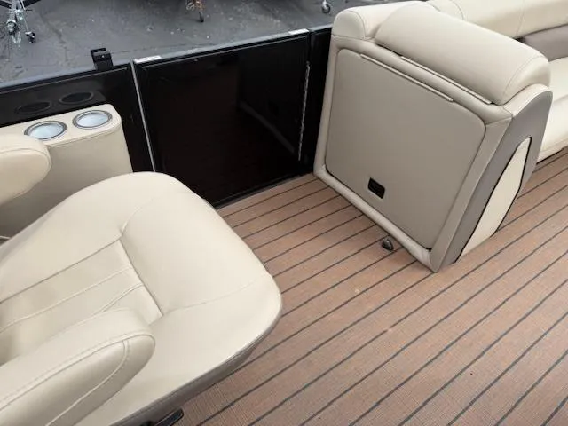 Slide: The Image of 2021 Bentley Pontoons 253 interior with beige seating and wood-style flooring. - 14