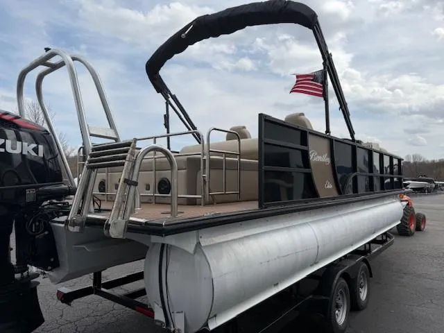 Slide: The Image of 2021 Bentley Pontoons 253 on trailer, featuring Suzuki outboard motor and American flag. - 3