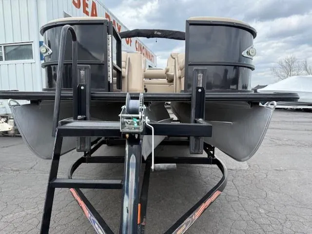 Slide: The Image of 2021 Bentley Pontoons 253 on trailer, parked outdoors, overcast sky. - 4
