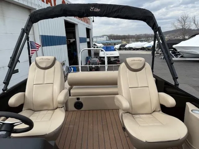 Slide: The Image of 2021 Bentley Pontoons 253 with beige seating and canopy, docked near a marina. - 5