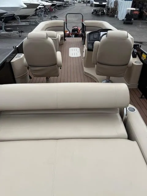 Slide: The Image of 2021 Bentley Pontoons 253 with beige seating and spacious deck layout. - 7