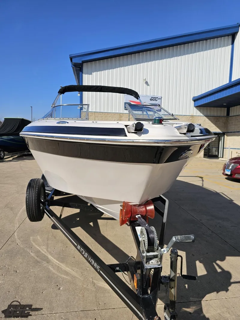 Slide: The Image of 2007 Four Winns 210 Horizon boat on trailer, parked outdoors. - 10