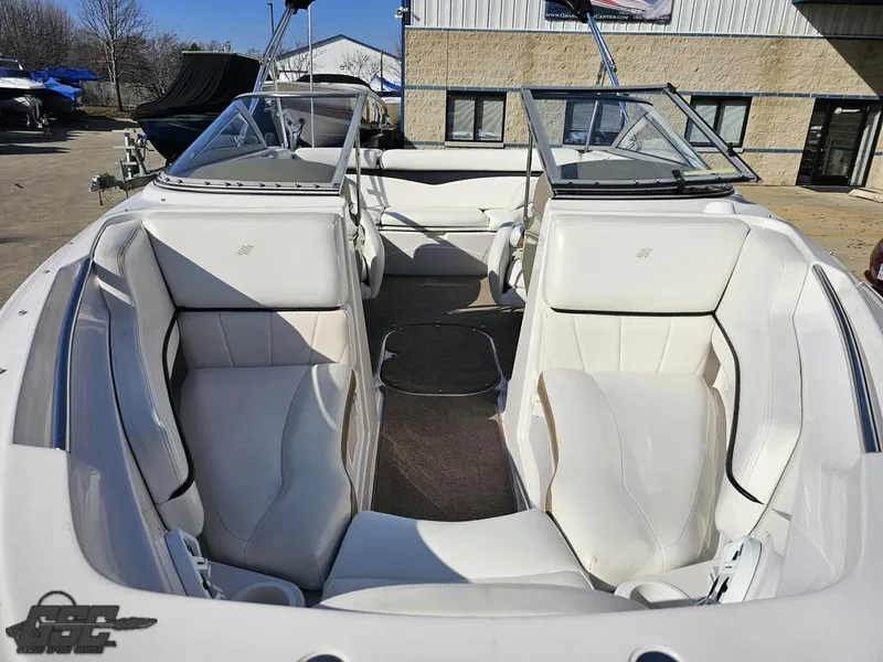 Slide: The Image of 2007 Four Winns 210 Horizon boat interior with white seating and open cockpit. - 11