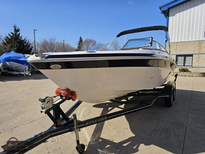 Slide: The Image of 2007 Four Winns 210 Horizon boat on trailer, parked outdoors. - 12