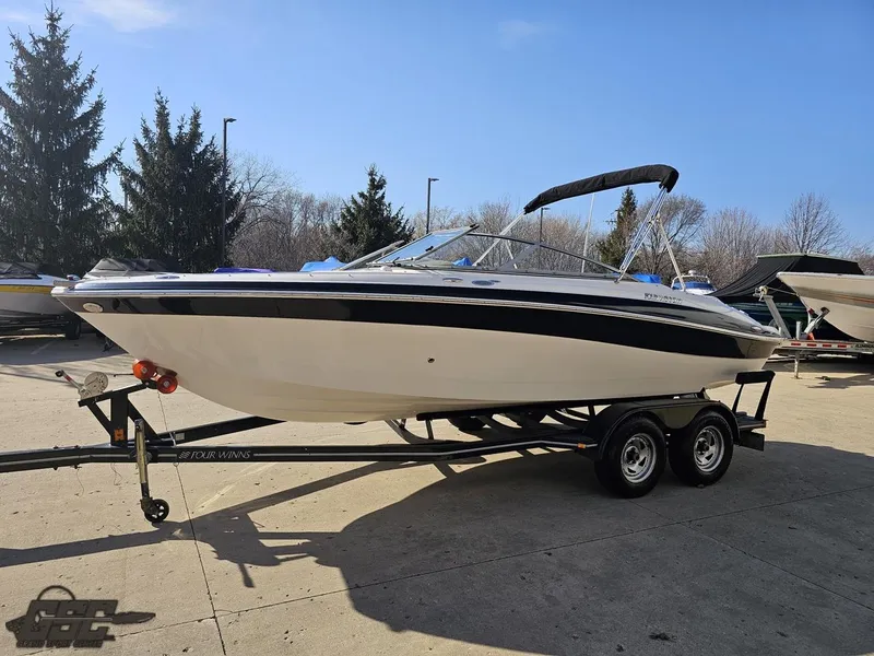 Slide: The Image of 2007 Four Winns 210 Horizon boat on trailer, parked outdoors. - 14