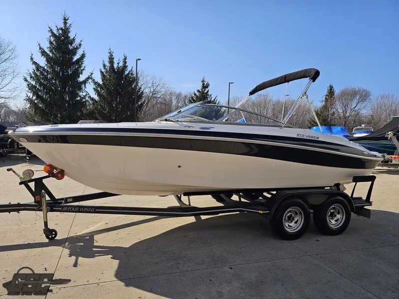 Slide: The Image of 2007 Four Winns 210 Horizon boat on trailer, parked outdoors. - 15