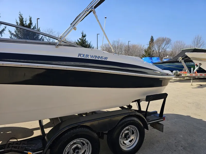 Slide: The Image of 2007 Four Winns 210 Horizon boat on trailer, parked outdoors. - 20