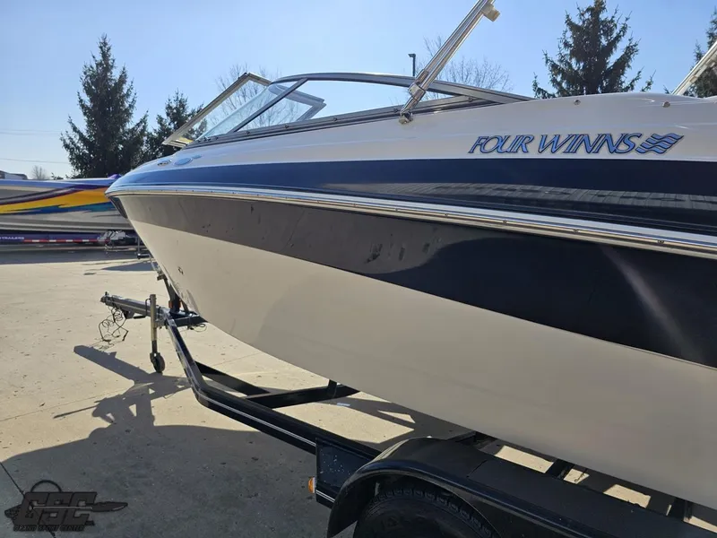 Slide: The Image of 2007 Four Winns 210 Horizon boat on trailer, parked outdoors. - 21