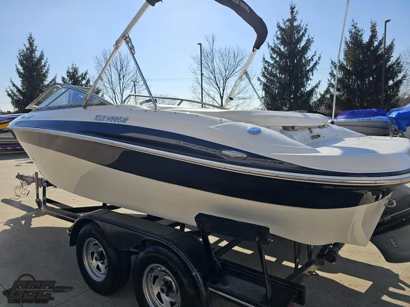 Slide: The Image of 2007 Four Winns 210 Horizon boat on trailer, parked outdoors. - 22