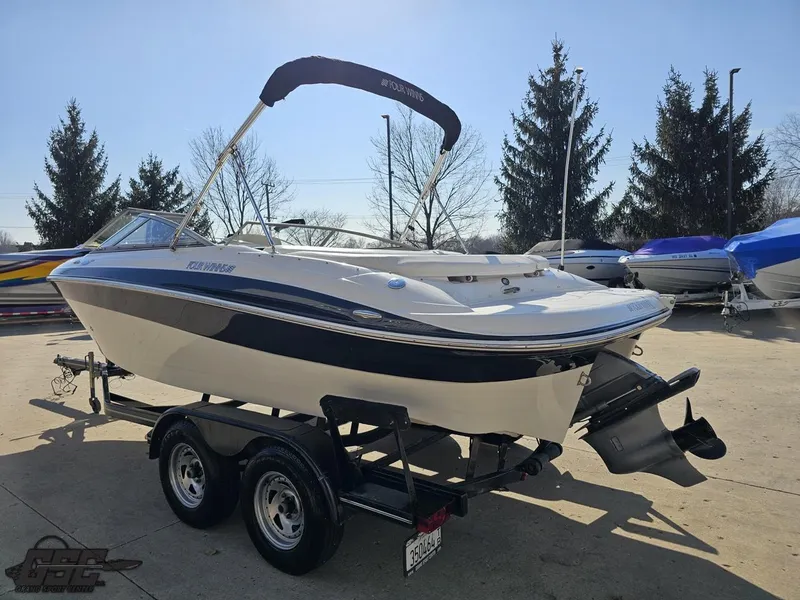 Slide: The Image of 2007 Four Winns 210 Horizon boat on trailer, parked outdoors. - 23