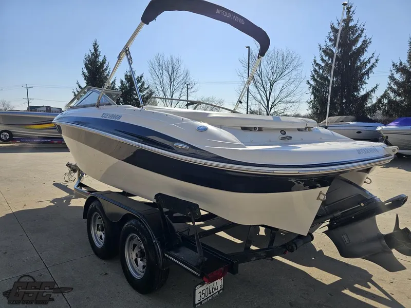 Slide: The Image of 2007 Four Winns 210 Horizon boat on trailer, parked outdoors. - 24