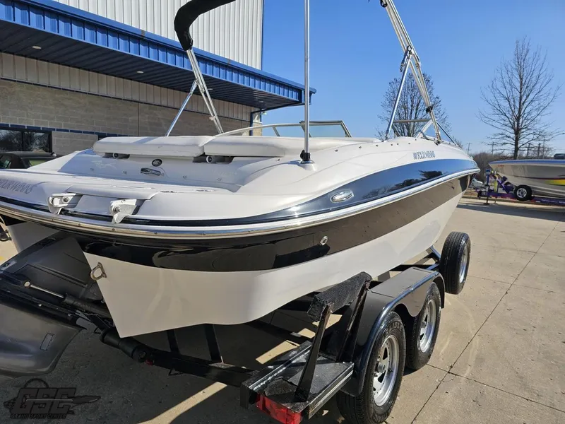 Slide: The Image of 2007 Four Winns 210 Horizon boat on trailer, parked outdoors. - 26