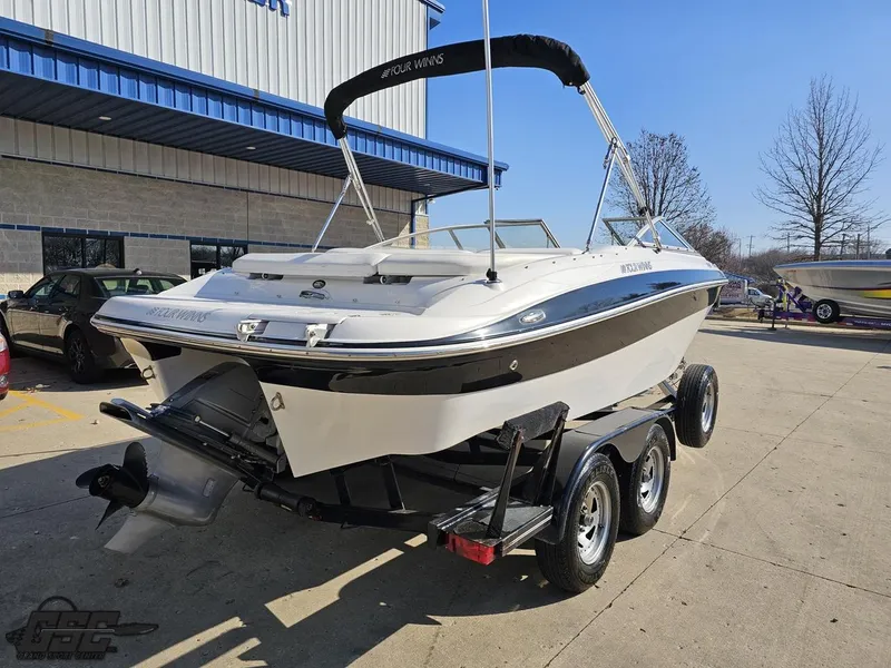 Slide: The Image of 2007 Four Winns 210 Horizon boat on trailer, parked outdoors. - 27
