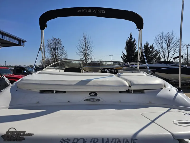 Slide: The Image of 2007 Four Winns 210 Horizon boat with canopy, rear view in outdoor setting. - 28