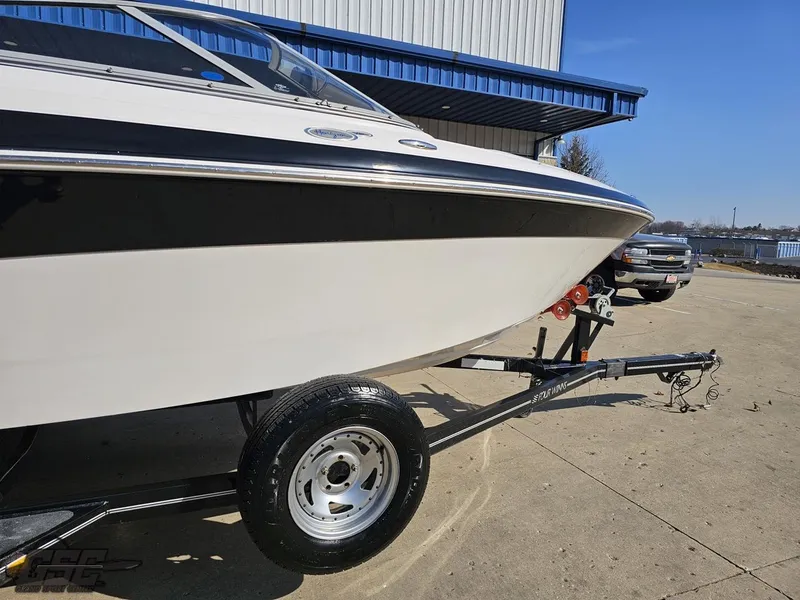 Slide: The Image of 2007 Four Winns 210 Horizon boat on trailer, parked outdoors near a building. - 3