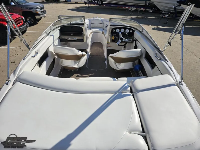 Slide: The Image of 2007 Four Winns 210 Horizon boat interior with white seating and dashboard view. - 30