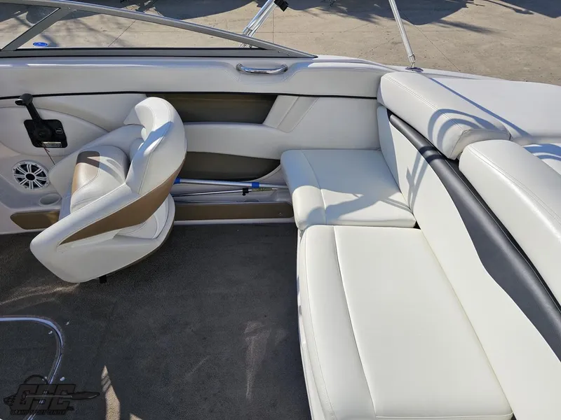 Slide: The Image of 2007 Four Winns 210 Horizon boat interior with white seating and steering wheel. - 39