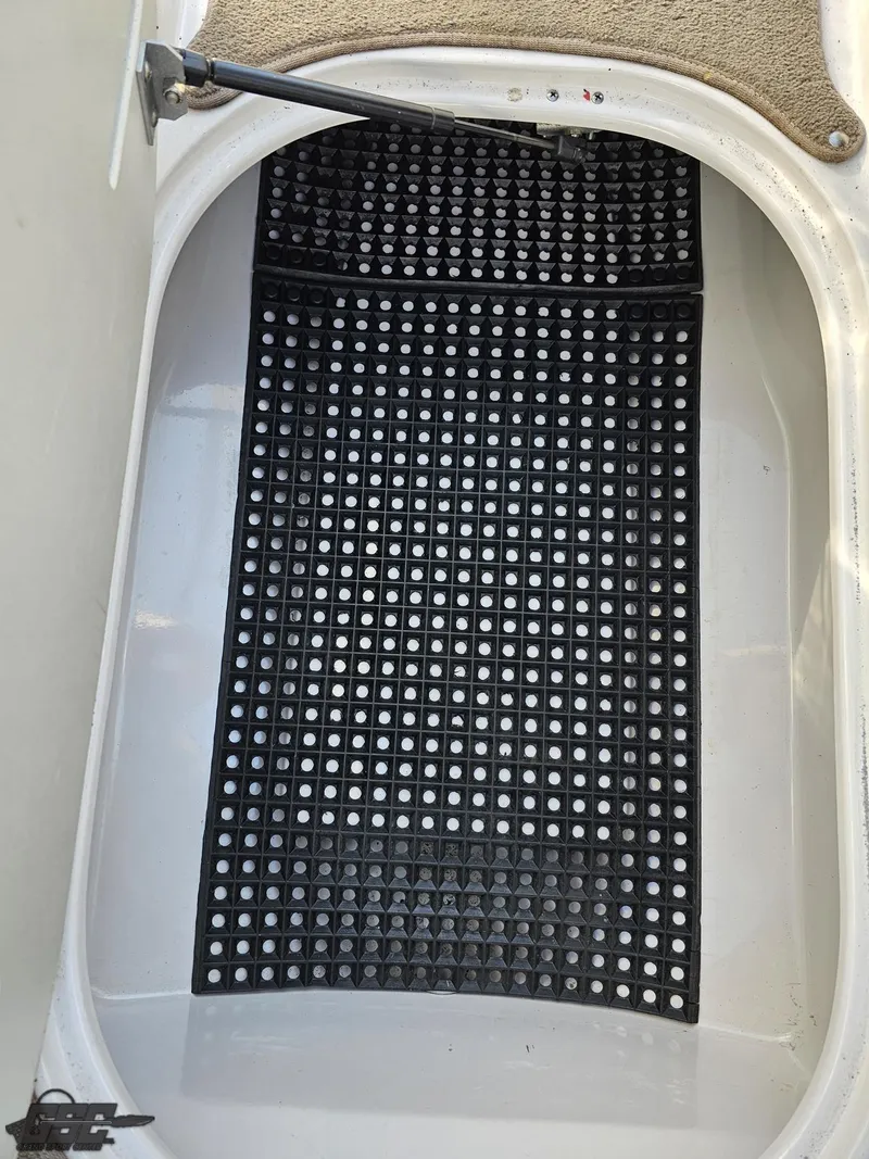 Slide: The Image of 2007 Four Winns 210 Horizon boat storage compartment with black grid mat. - 48