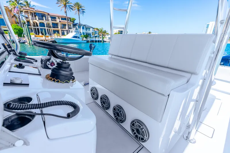 Slide: The Image of 2023 Contender 39ST boat interior with white seating and modern controls. - 33