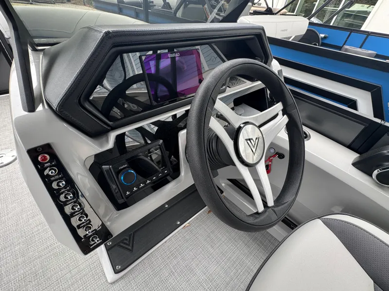 Slide: The Image of 2025 Viaggio Lago X-S boat dashboard with modern steering wheel and control panel. - 7