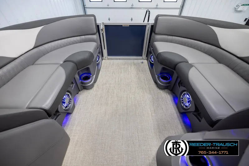 Slide: The Image of 2022 Avalon 2285 LSZ CRB boat interior with plush seating and blue LED lighting. - 18