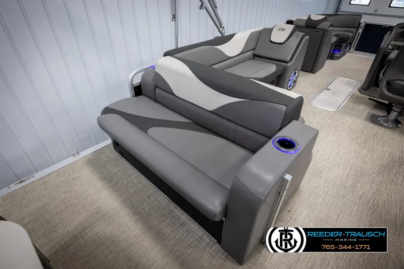 Slide: The Image of 2022 Avalon 2285 LSZ CRB boat interior with gray seating and cup holders. - 24