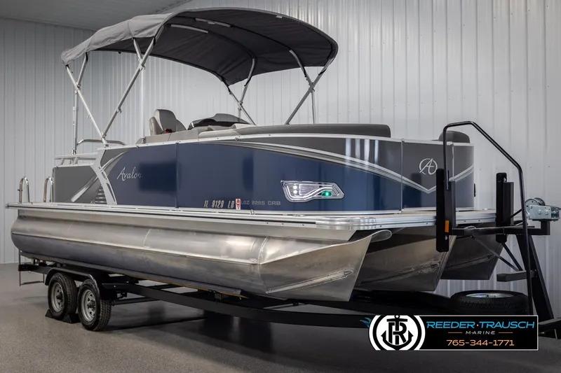 Slide: The Image of 2022 Avalon 2285 LSZ CRB pontoon boat on trailer in indoor storage. - 3