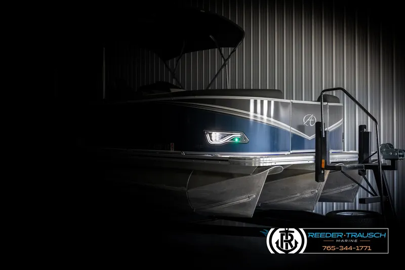 Slide: The Image of 2022 Avalon 2285 LSZ CRB pontoon boat in a dimly lit showroom. - 4