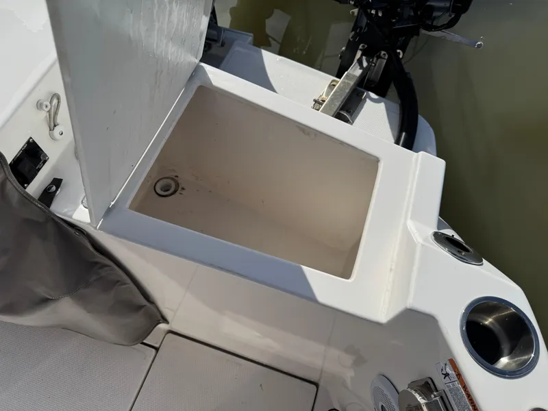 Slide: The Image of 2021 Cutwater C-24 Coupe boat storage compartment with open lid, showing interior details. - 10