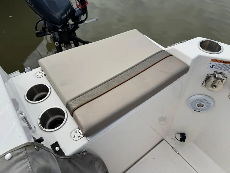 Slide: The Image of 2021 Cutwater C-24 Coupe boat seating area with cup holders and speaker. - 11