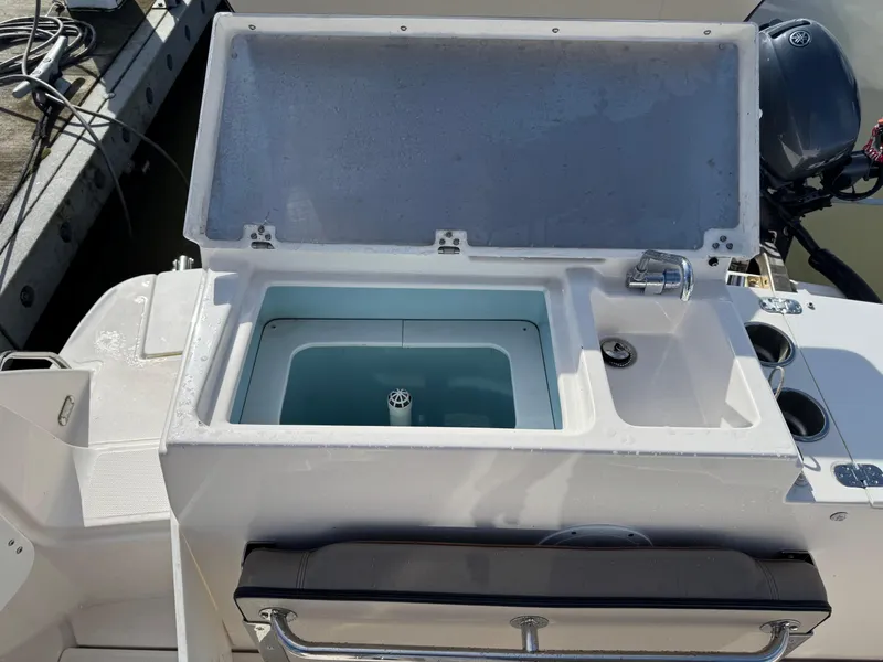 Slide: The Image of 2021 Cutwater C-24 Coupe boat with open storage compartment and seating area. - 14