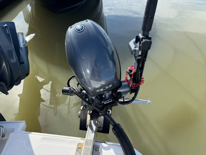 Slide: The Image of Outboard motor on a 2021 Cutwater C-24 Coupe, docked in calm water. - 16