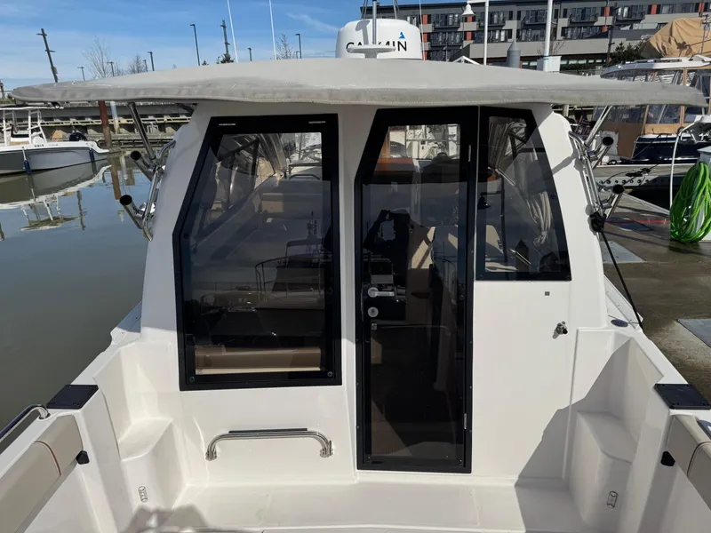 Slide: The Image of 2021 Cutwater C-24 Coupe boat docked at marina, rear view of cabin entrance. - 19