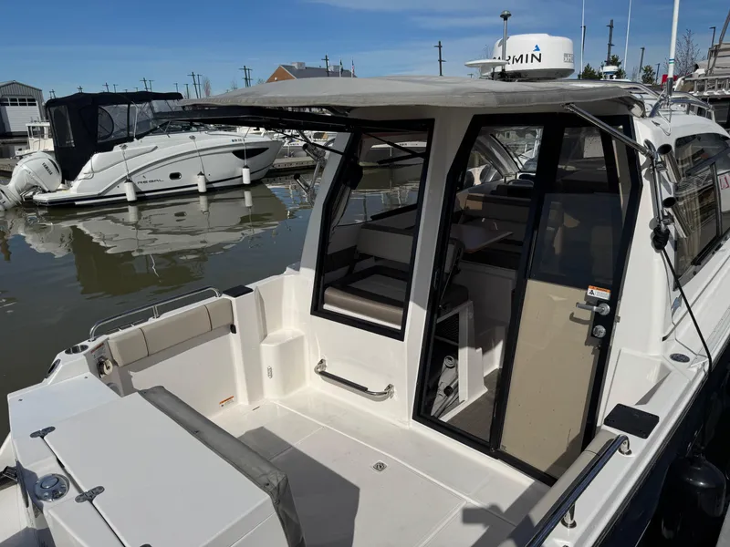 Slide: The Image of 2021 Cutwater C-24 Coupe boat docked, showcasing spacious cockpit and sleek design. - 20