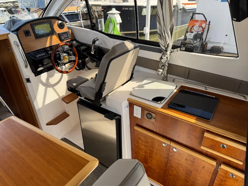 Slide: The Image of Interior of 2021 Cutwater C-24 Coupe boat with helm, seating, and kitchenette. - 21