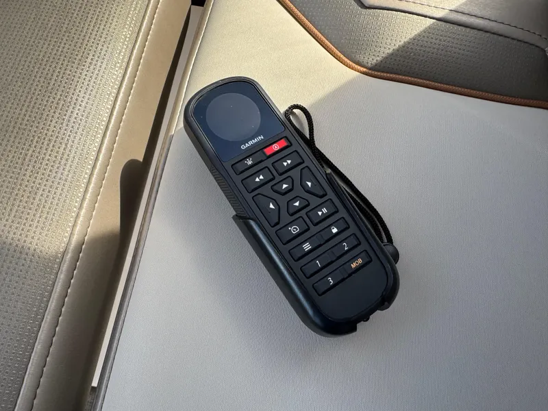 Slide: The Image of Remote control on beige seat of 2021 Cutwater C-24 Coupe boat. - 25