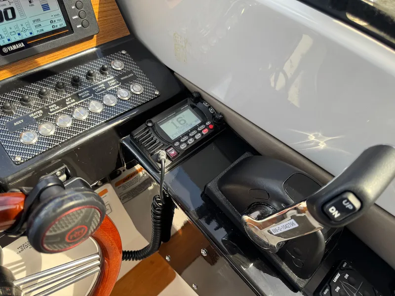 Slide: The Image of 2021 Cutwater C-24 Coupe helm with controls, radio, and steering wheel. - 27