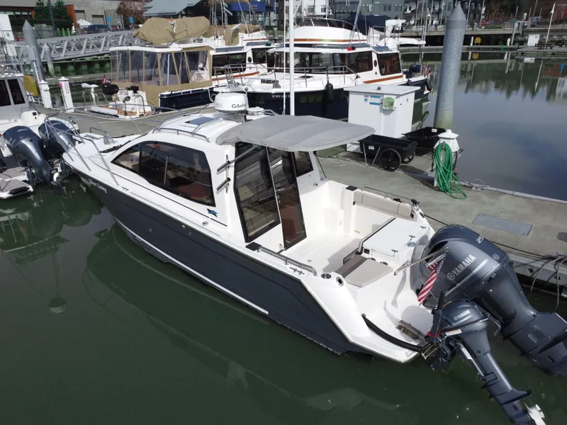 Slide: The Image of 2021 Cutwater C-24 Coupe boat docked with twin Yamaha outboard engines. - 3