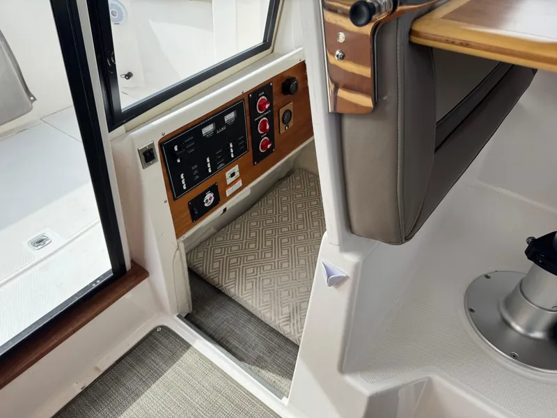 Slide: The Image of Interior view of 2021 Cutwater C-24 Coupe, featuring control panel and seating area. - 39