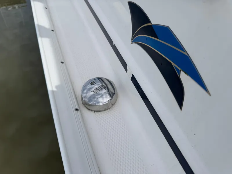 Slide: The Image of 2021 Cutwater C-24 Coupe diesel cap and logo detail on boat exterior. - 45