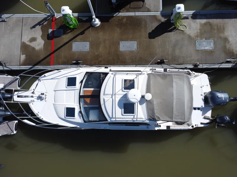 Slide: The Image of 2021 Cutwater C-24 Coupe docked, aerial view showcasing sleek design and modern features. - 5