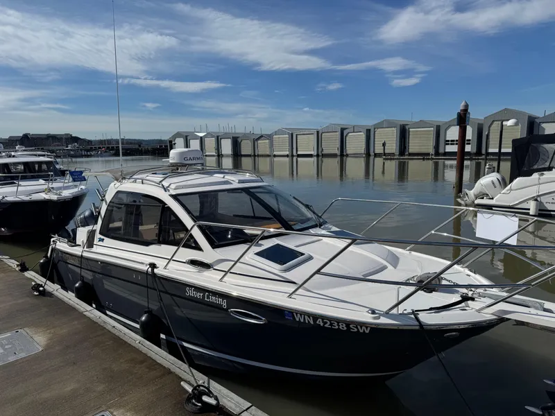 Slide: The Image of 2021 Cutwater C-24 Coupe docked at marina under clear blue sky. - 51