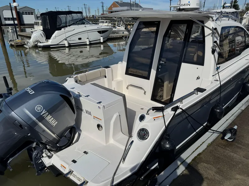 Slide: The Image of 2021 Cutwater C-24 Coupe docked, featuring Yamaha outboard motor, sleek design, and spacious cockpit. - 6