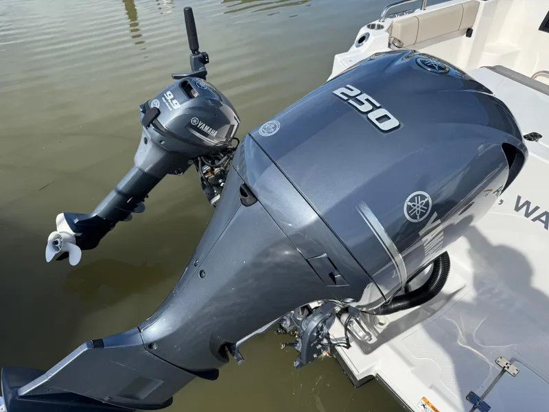 Slide: The Image of Yamaha outboard motors on a 2021 Cutwater C-24 Coupe boat, docked on calm water. - 7