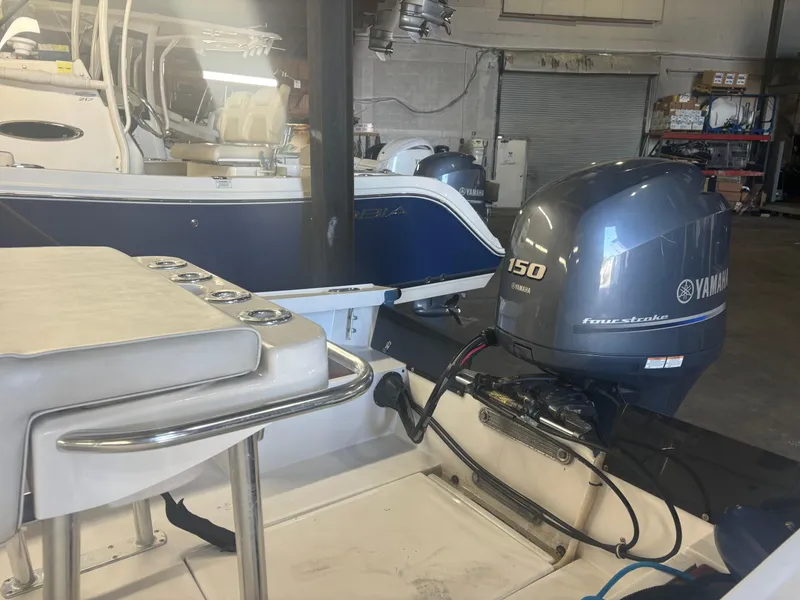 Slide: The Image of 1971 SeaCraft Barcone 21 CC with Yamaha 150 outboard motor in a garage setting. - 12