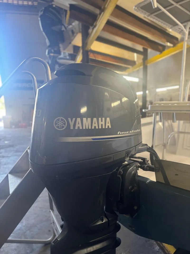 Slide: The Image of Yamaha outboard motor on 1971 SeaCraft Barcone 21 CC boat in a workshop setting. - 13