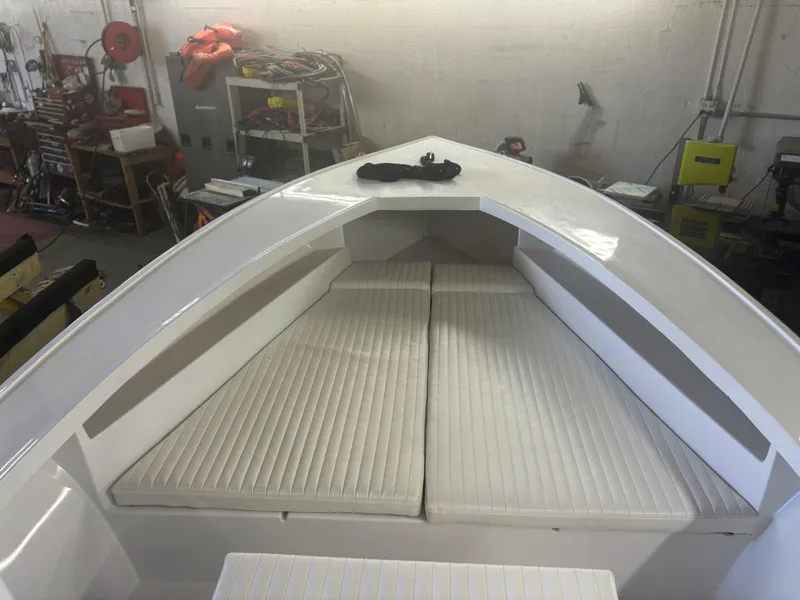 Slide: The Image of 1971 SeaCraft Barcone 21 CC boat interior with cushioned seating in a workshop. - 4