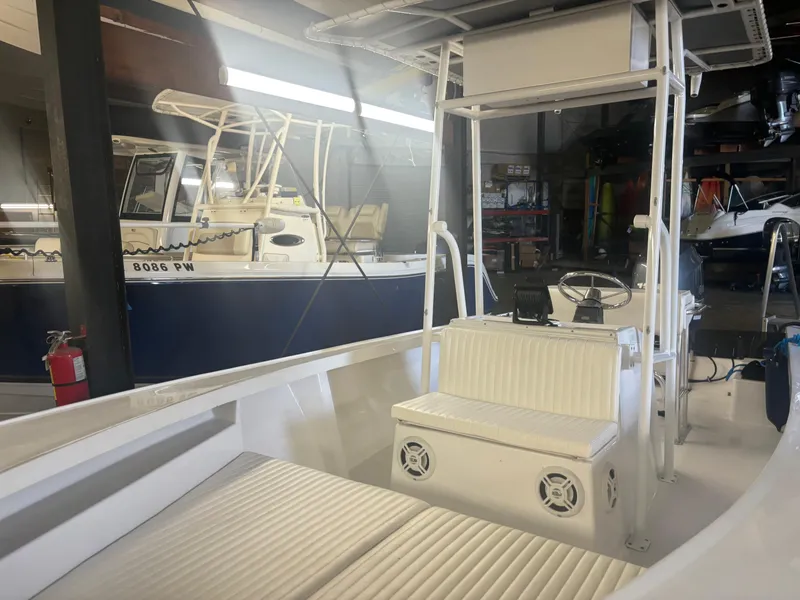 Slide: The Image of 1971 SeaCraft Barcone 21 CC boat interior with white seating and steering console. - 6