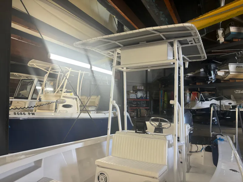 Slide: The Image of 1971 SeaCraft Barcone 21 CC boat in a storage facility, featuring a center console. - 7